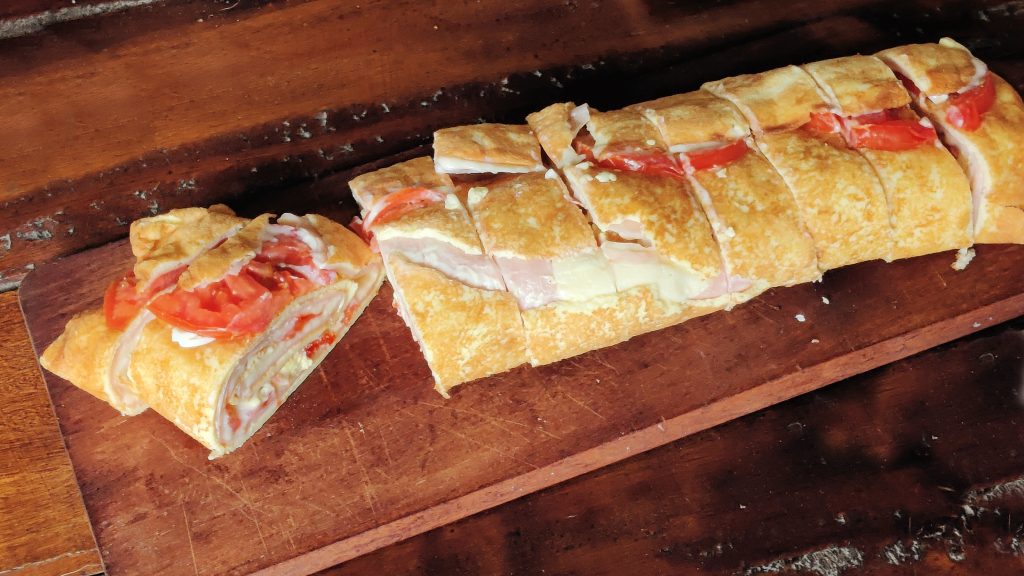 Pionono with tomato, cheese, ham, mayonnaise.